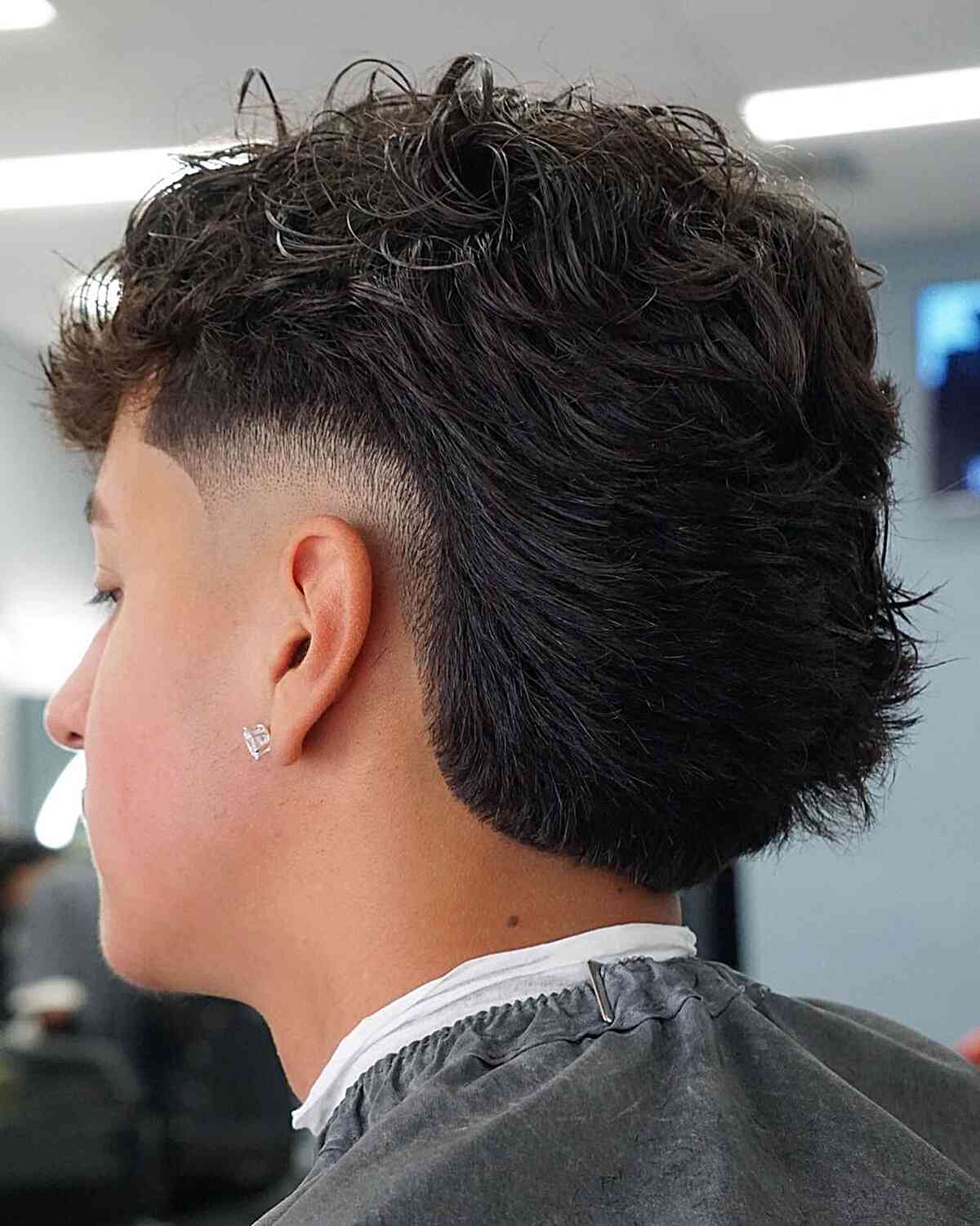 Medium-Length Textured Mullet with Low Burst Fade for Young Men