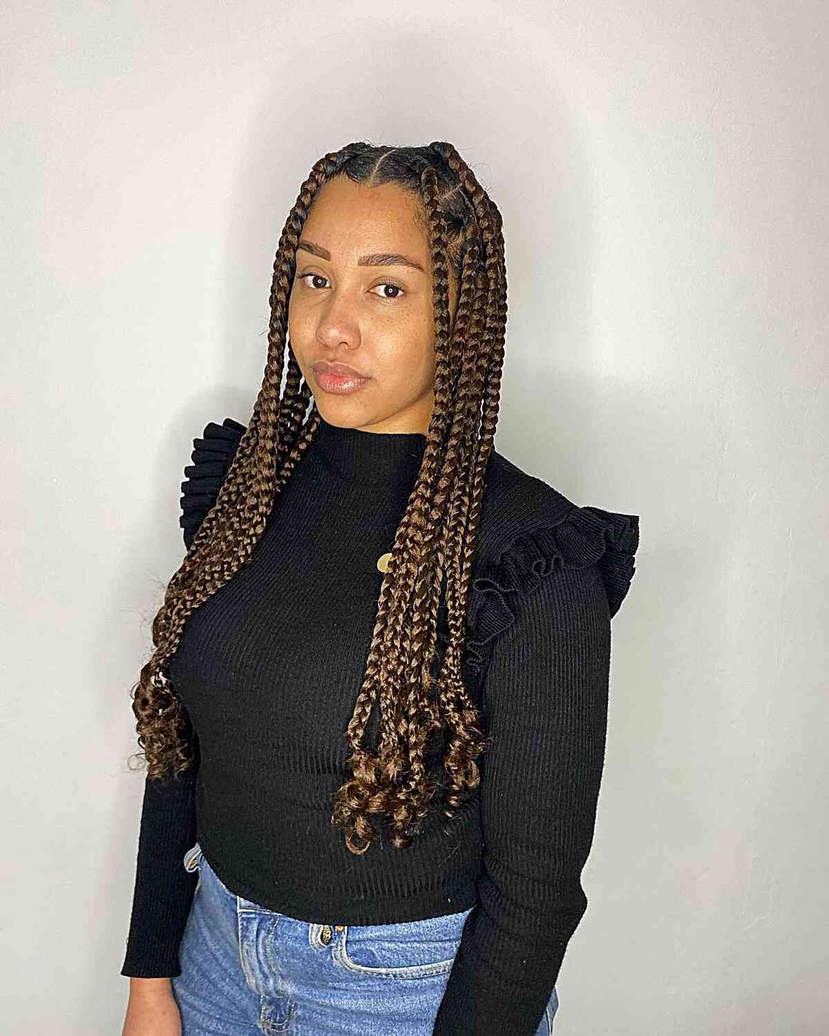 Long-Length Middle Part Brown Large Knotless Braids with Curled Ends
