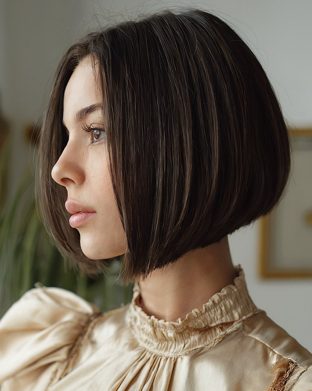 Chin-length pinch bob with soft tapering and beveled ends on straight hair