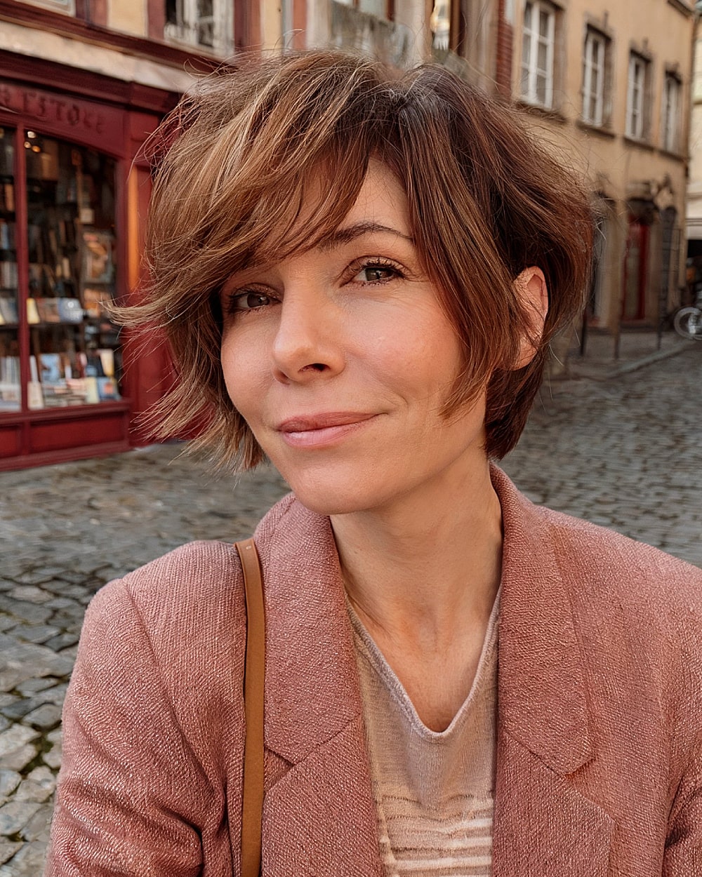 Pixie bob haircut with side bangs and feathered layers for women over 40