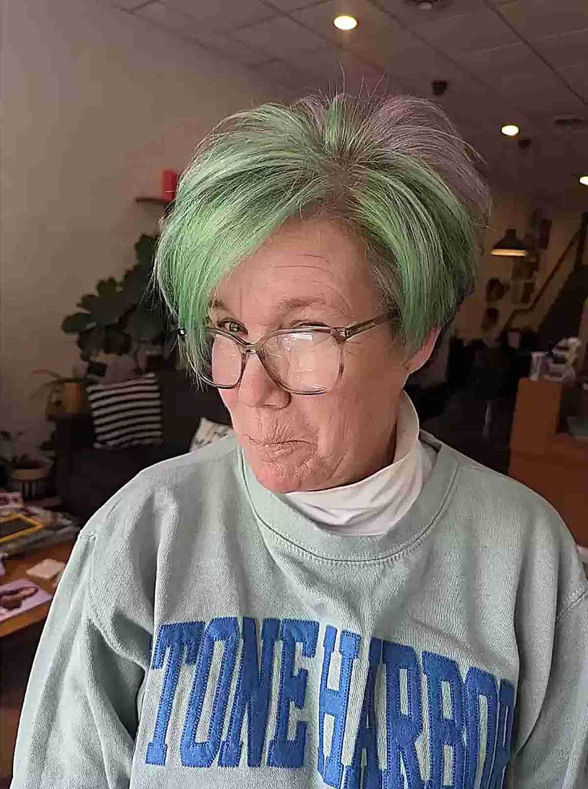 Pixie with Green Highlights and Long Side Bangs for Ladies Over 50 with Glasses