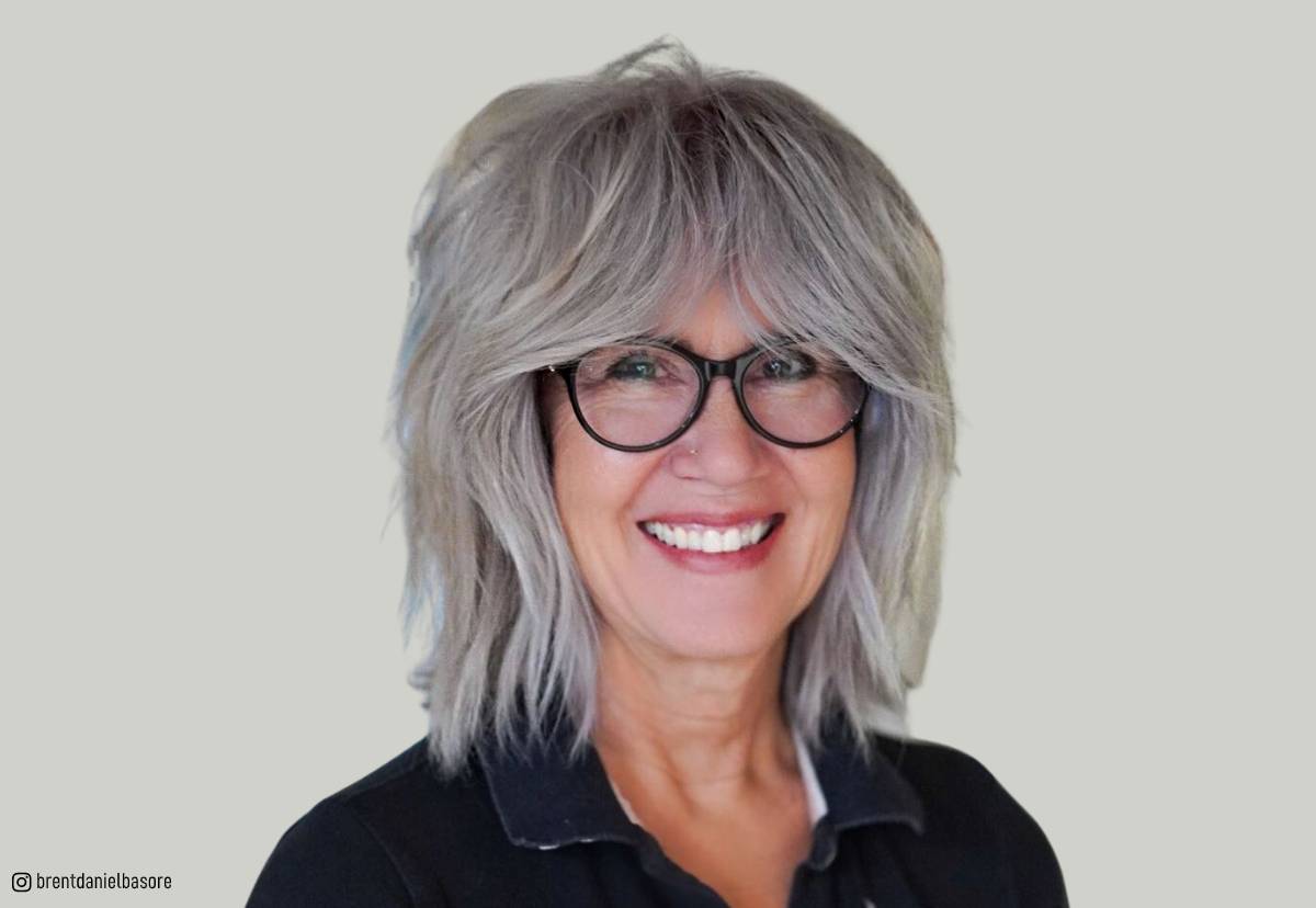 Image of Layered shag haircut with blunt bangs for women over 60