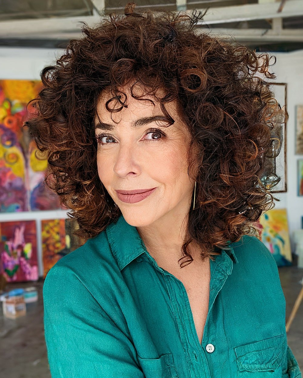 Short shaggy haircut for naturally curly hair with defined layers and volume for older women