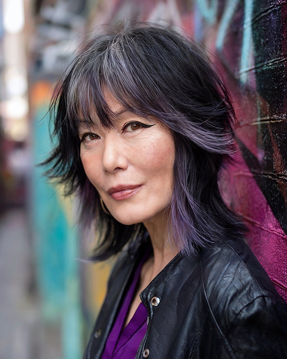 Jellyfish shag haircut with two-tier layers and bold purple accents for women over 50