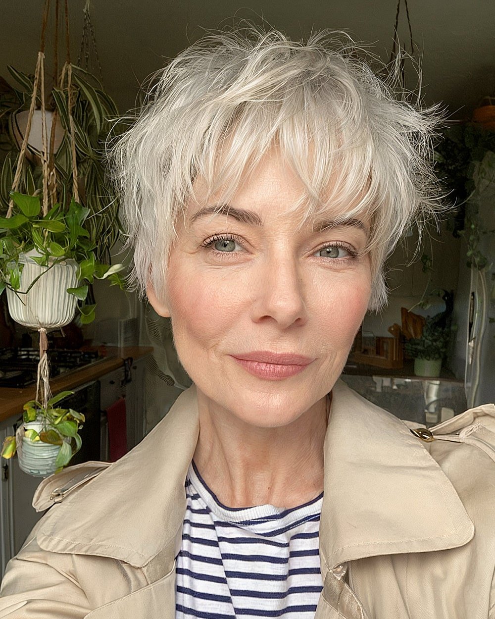 Textured shaggy pixie cut with choppy layers and wispy bangs for stylish women over 50