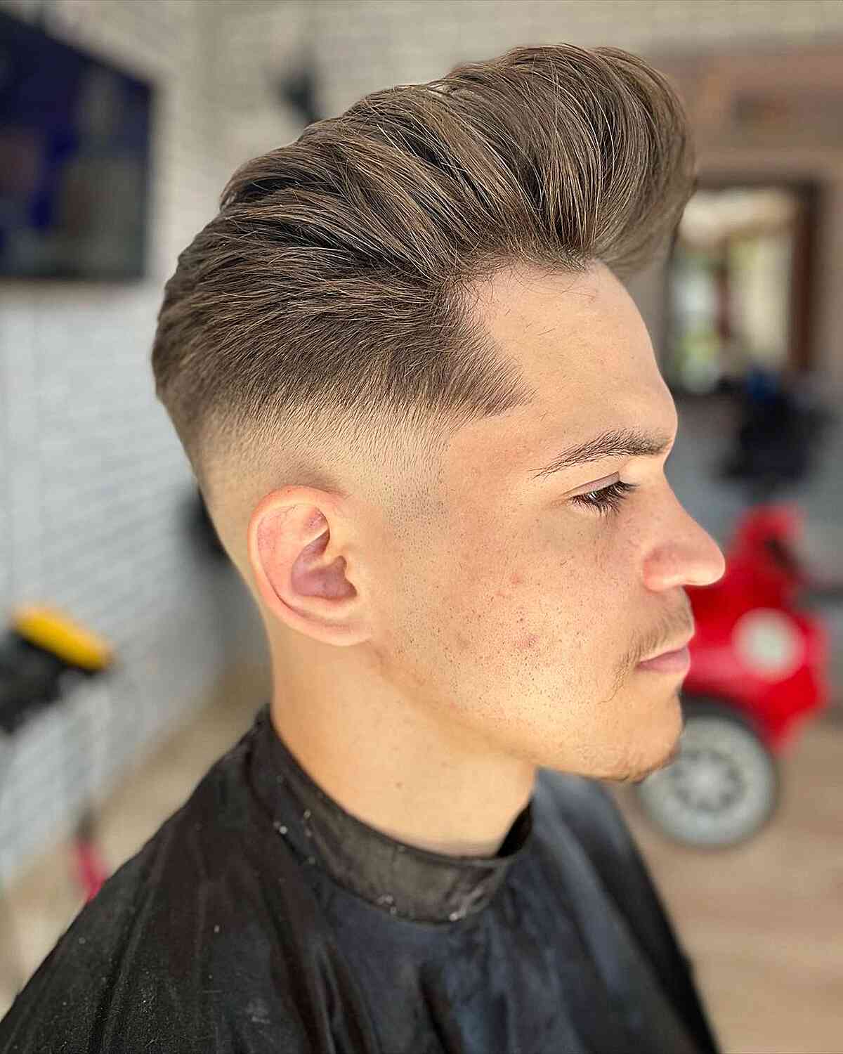 Sharp Bald Fade on Pompadour Hair for Men's Long Face Shape