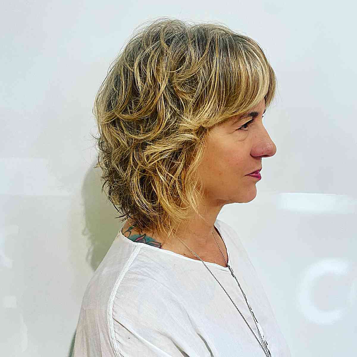 Short Hair with Shaggy Layers and Straight Bangs for Mature Women Over Fifty