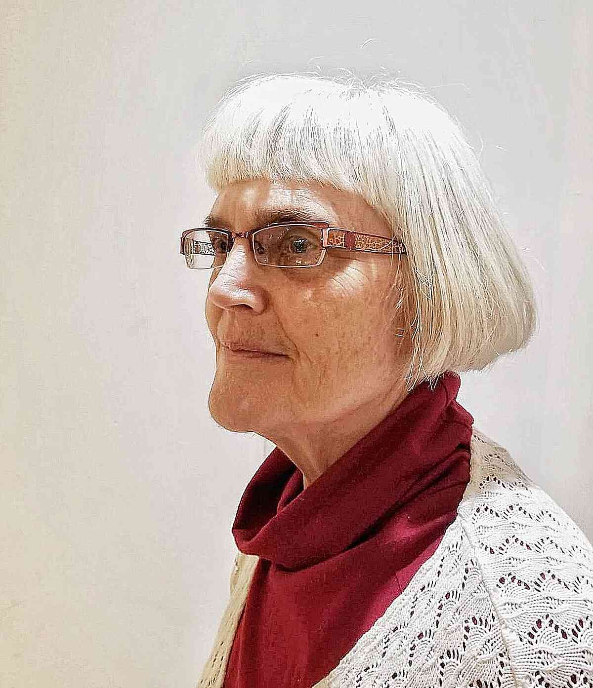 Short One-Length Thick Cut with Blunt Bangs for ladies in their 60s with glasses