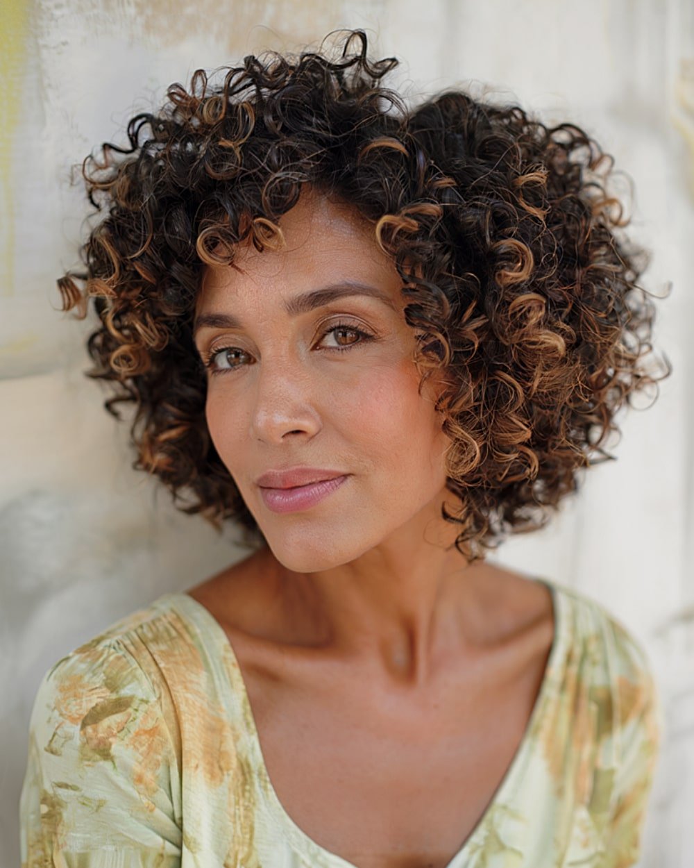Side-parted stacked curly bob with bouncy spirals and dimensional color