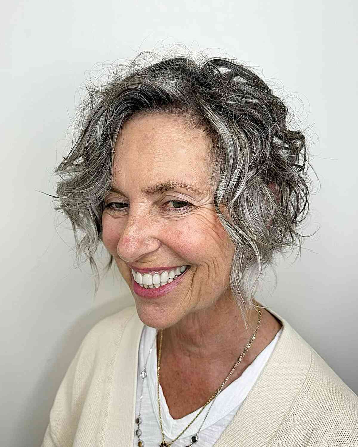 Ear-Length Silver Tousled Bob with Dark Roots for Senior Women