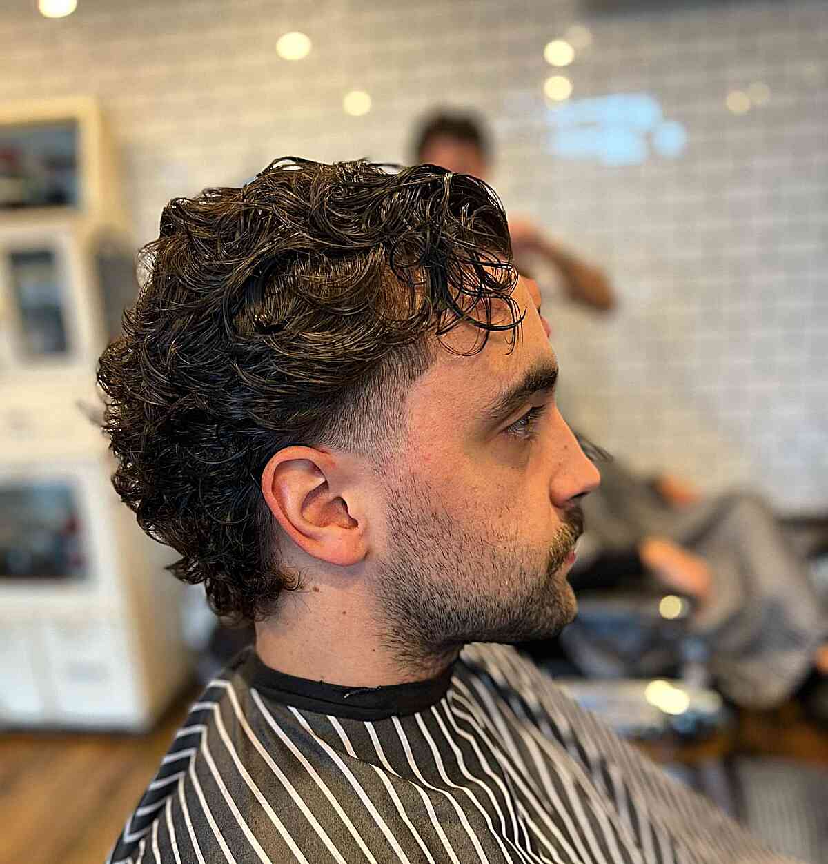 Soft Slicked Back Curly Hair with Low Fade for Men