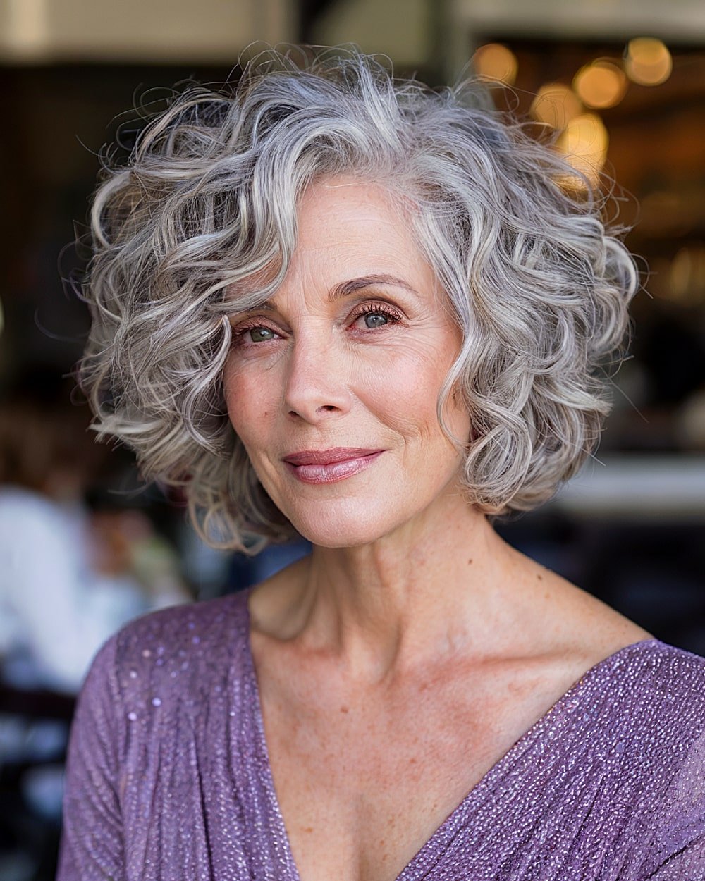 Stacked curly bob with face-framing layers and soft silver curls