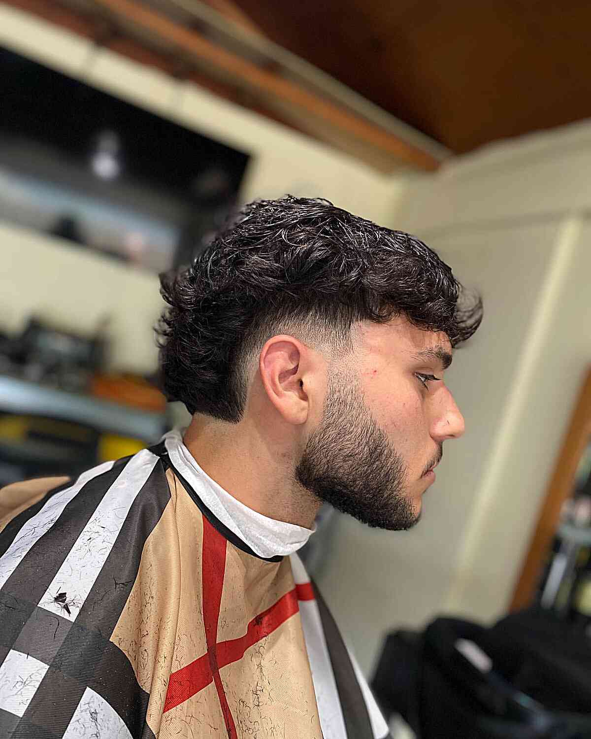 Textured Low Burst Fade Haircut with Beard Line-Up for Men