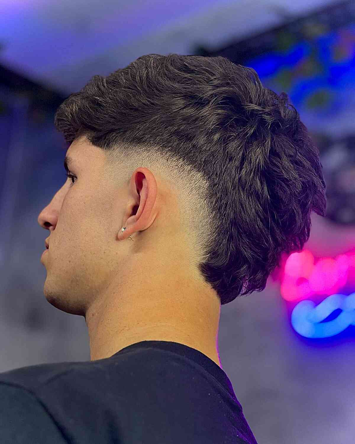 Thick Wavy Hair with a Mid Burst Fade for Boys