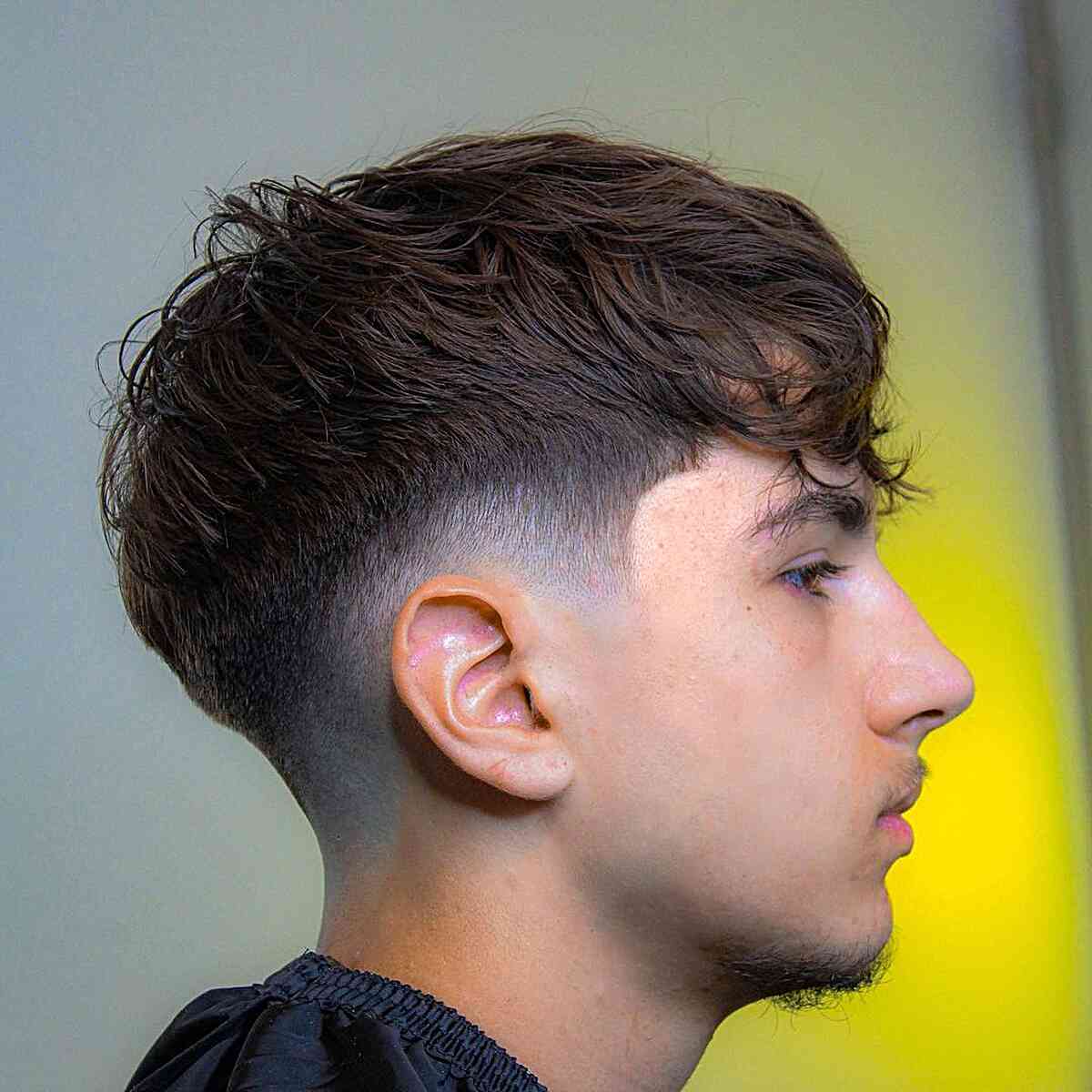 Tousled Wavy Hair with Low Tapered Burst Fade on Gents