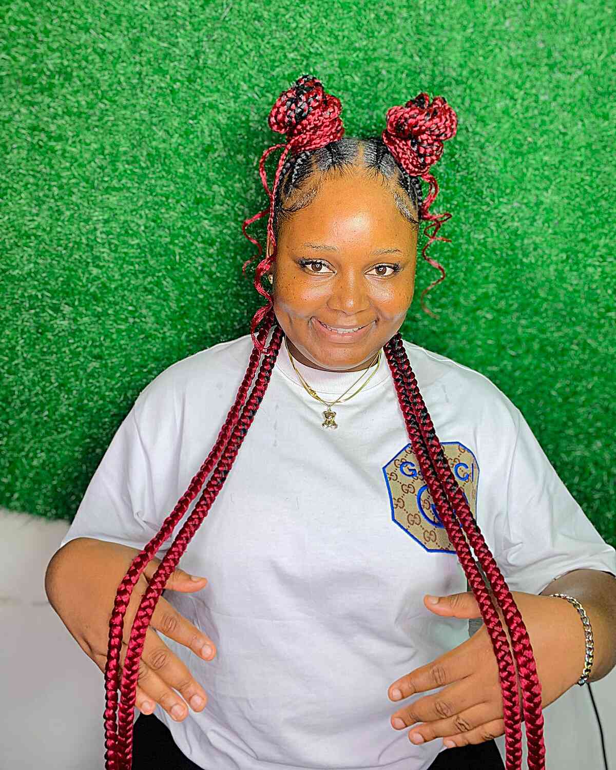 Long Vibrant Red Braids with Half-Up Space Buns for a Black Woman