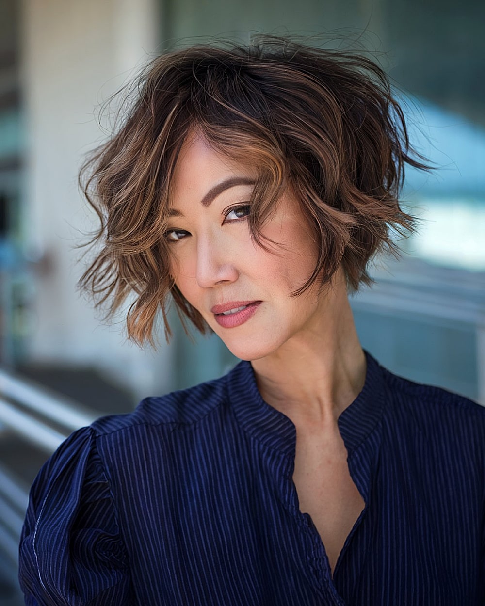 Tousled wavy pixie bob haircut with disconnected layers for women over 40