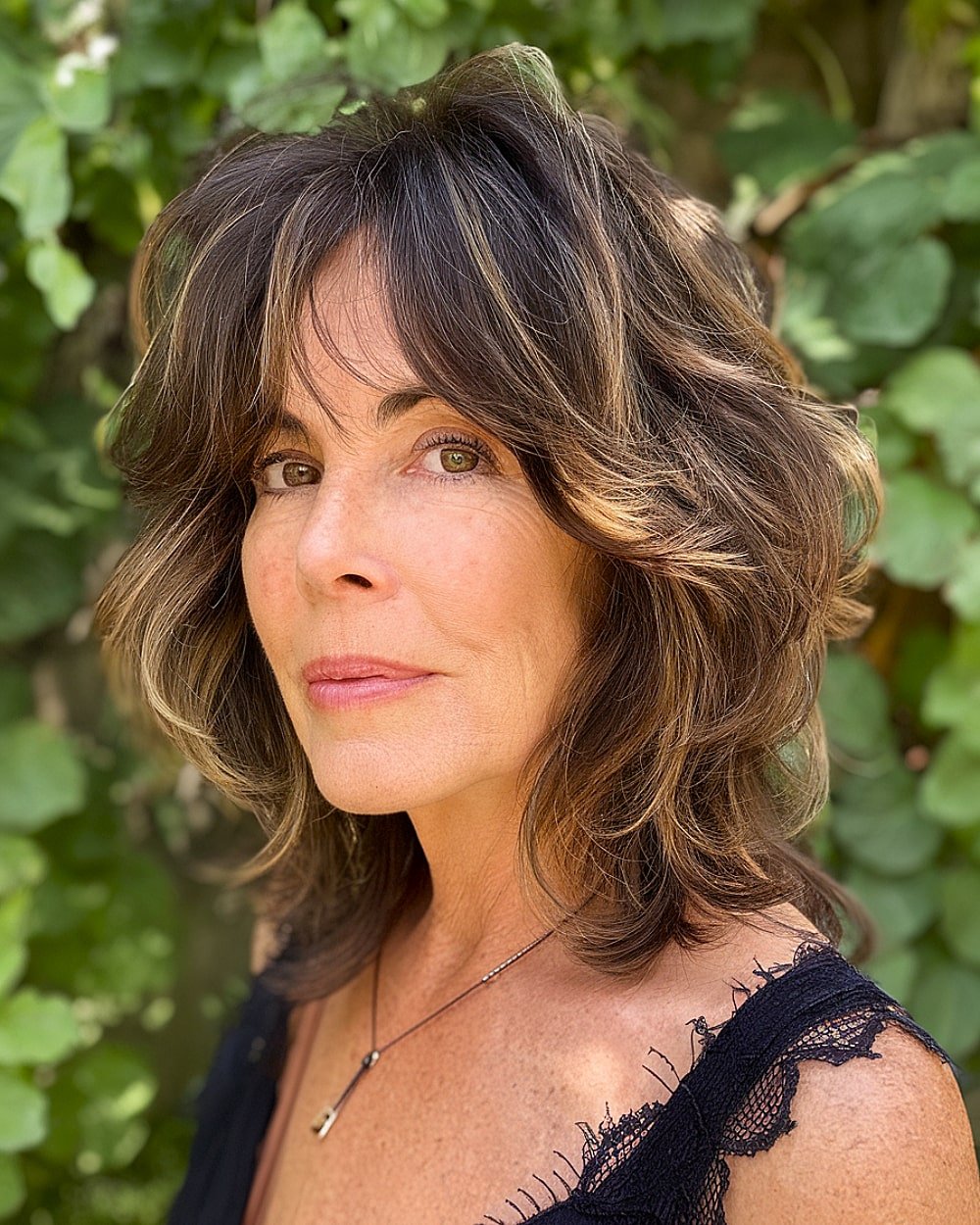 Soft shag haircut with wispy layers and face-framing feathered ends for women over 50