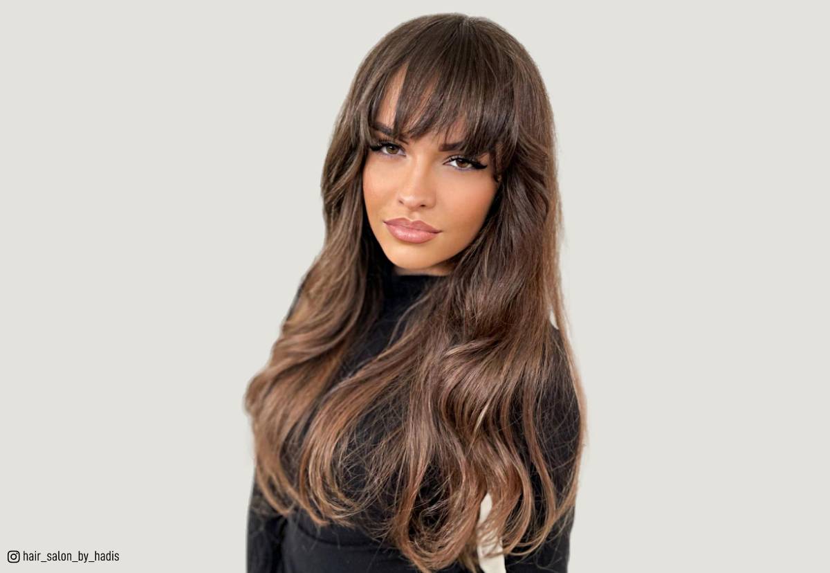 Image of Woman with long straight hair getting blunt layered haircut with long wispy bangs